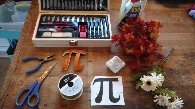 A picture of a workbench with various tools and a stencil of a pi symbol.